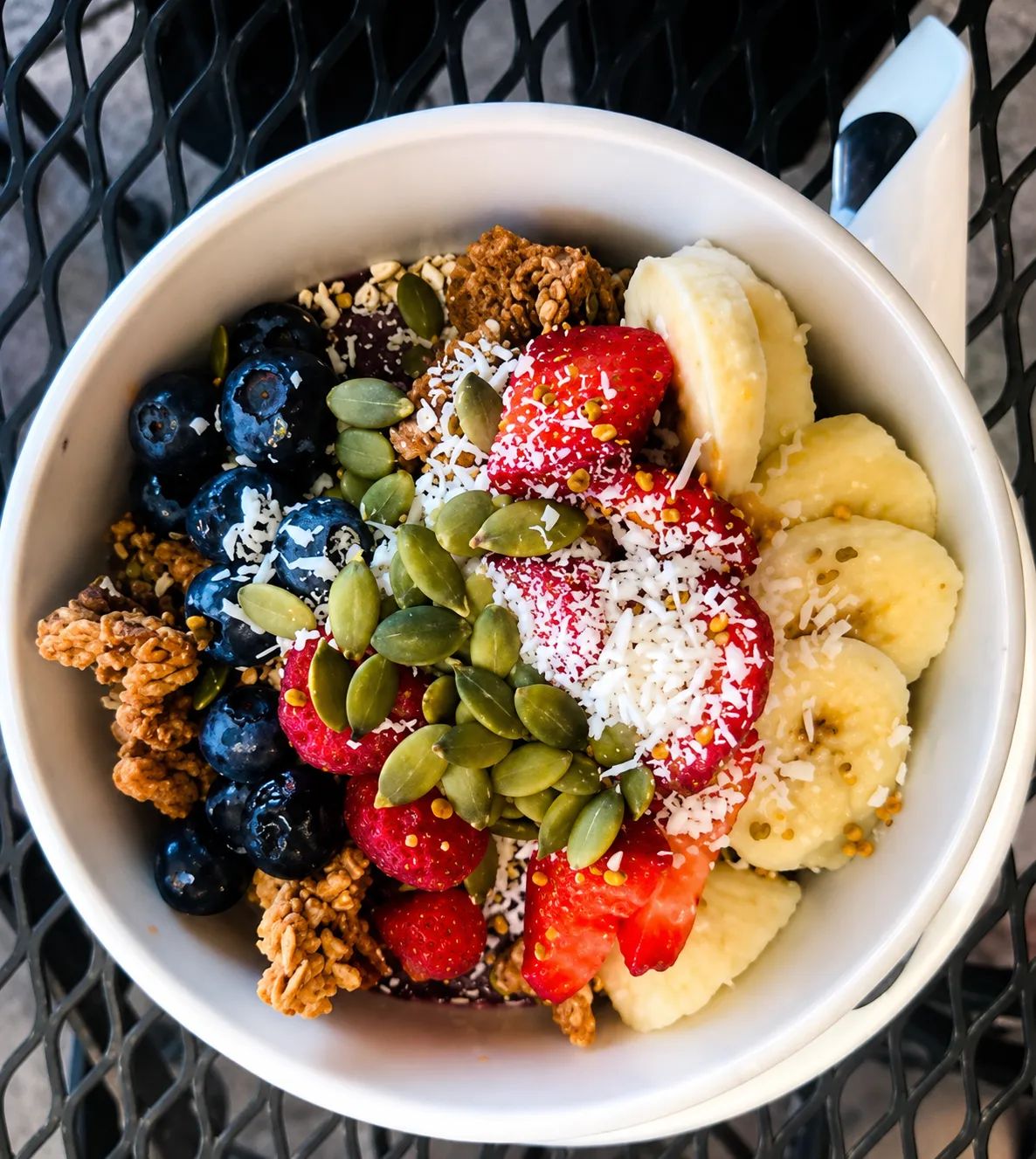 Yogurt bowl with fruit, granola, and seeds